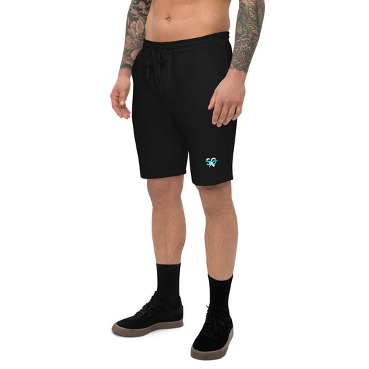 a man with a tattooed arm wearing black shorts
