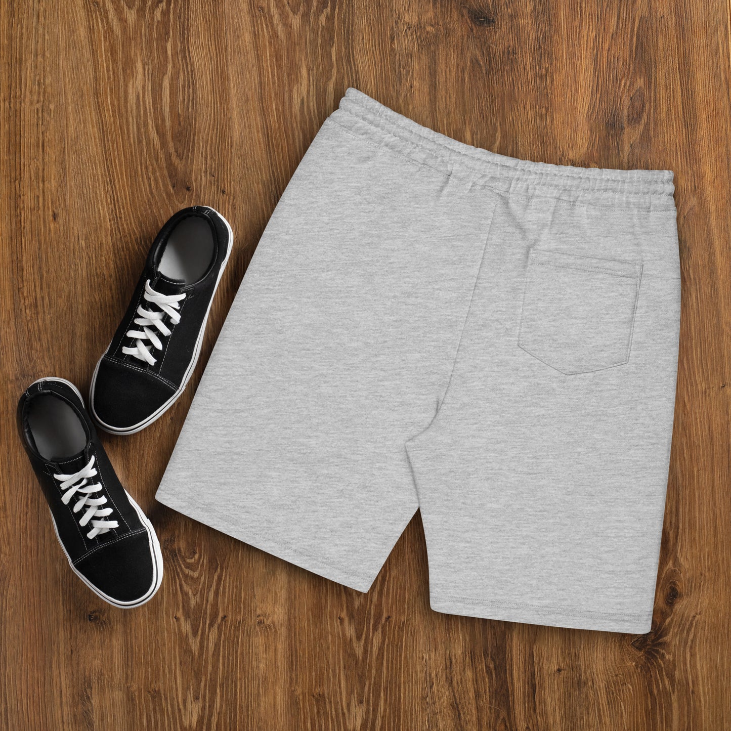 a pair of sneakers and a pair of shorts on a wooden floor