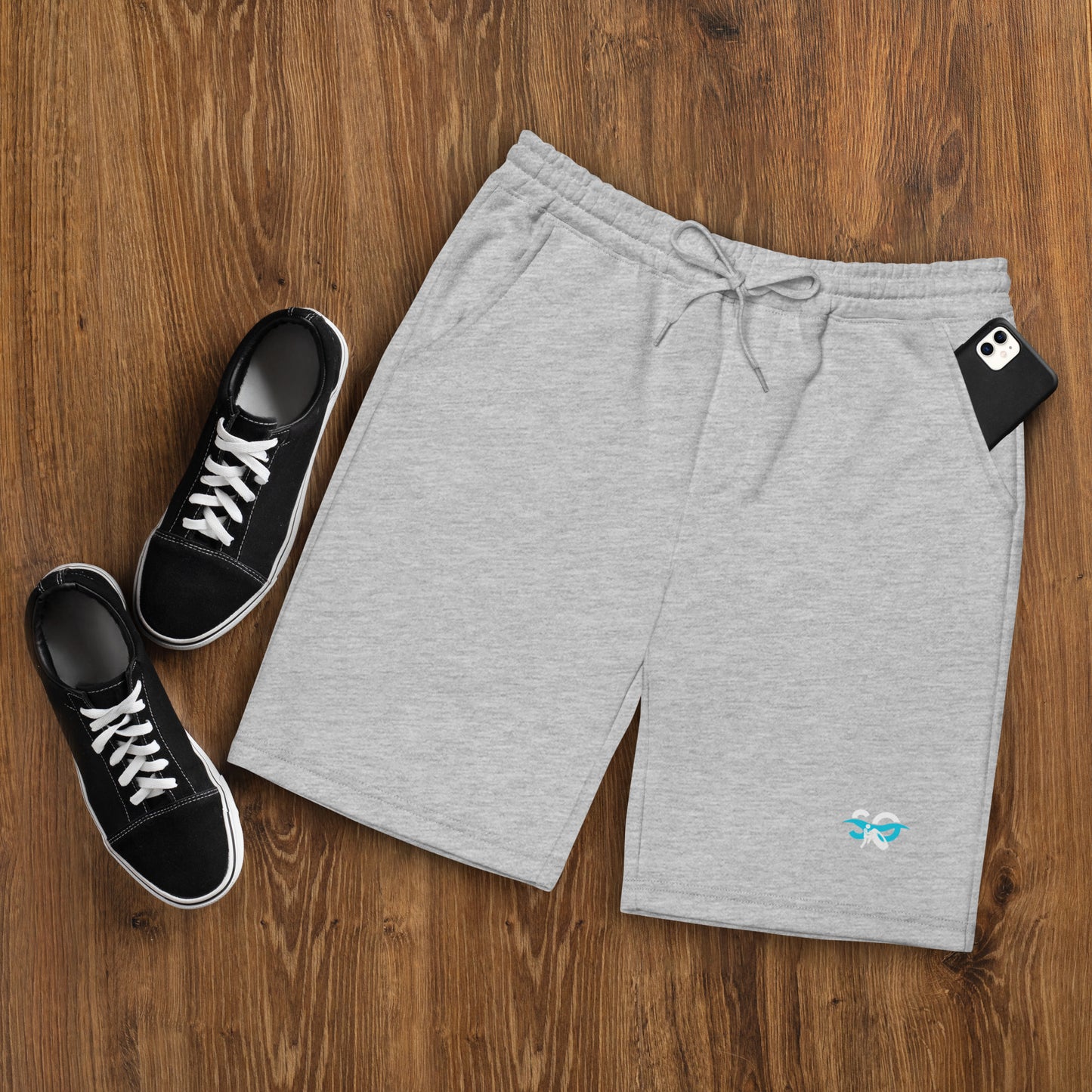 a pair of sneakers and a pair of shorts on a wooden floor