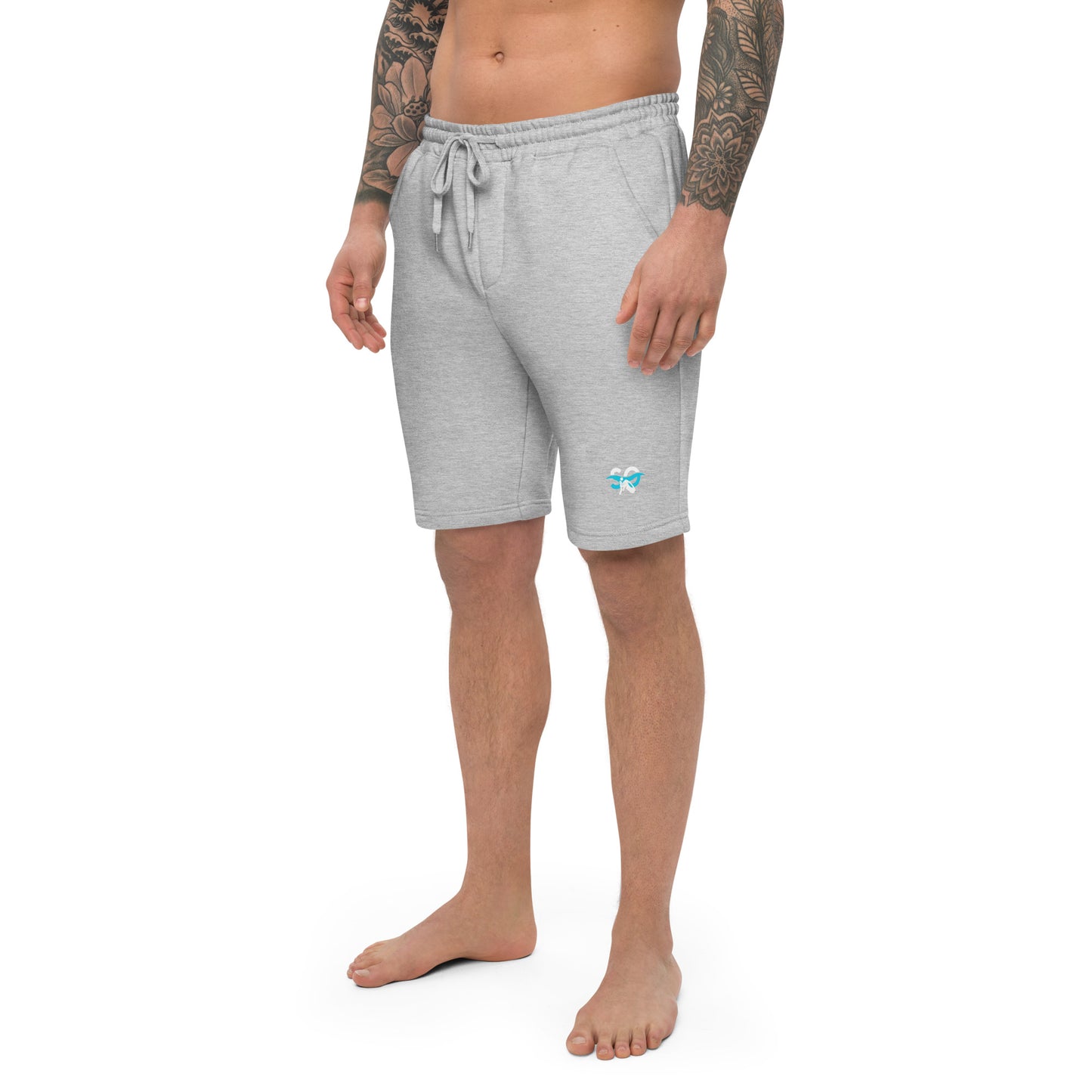 a man with a tattoo on his arm wearing grey shorts