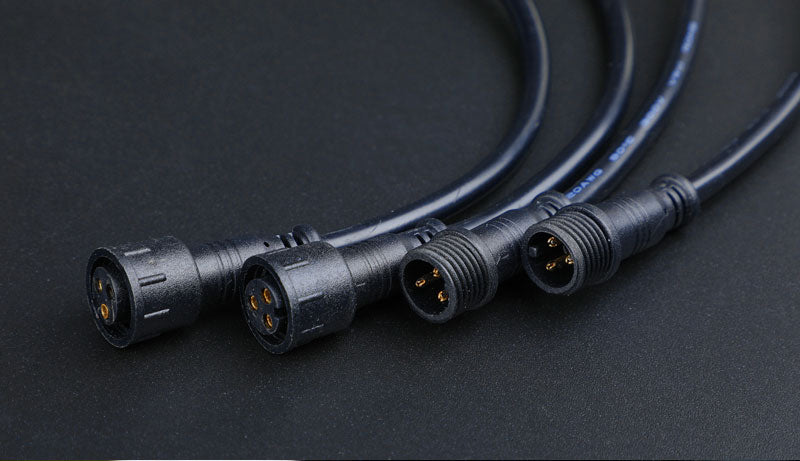 a close up of three black wires on a table