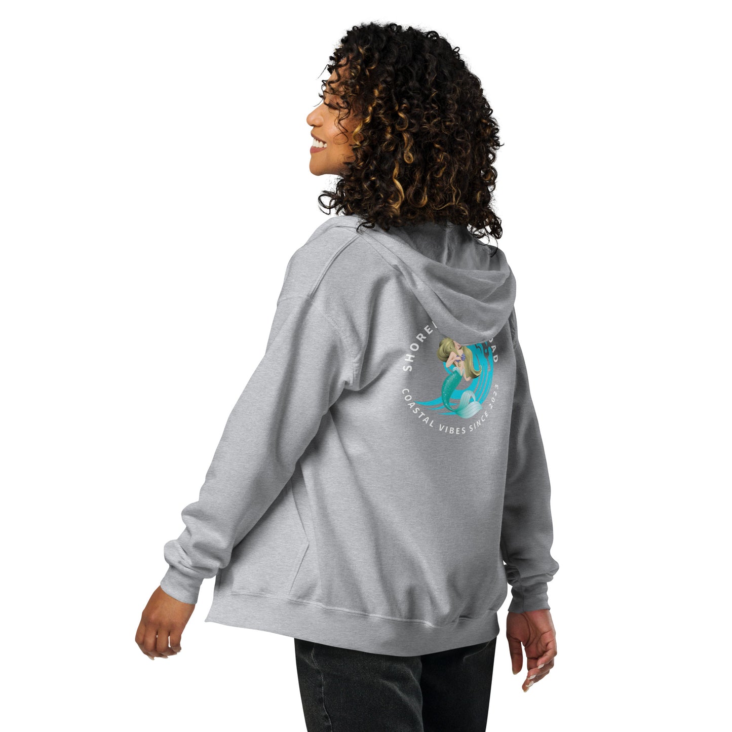 a woman wearing a gray hoodie with a picture of a mermaid on it