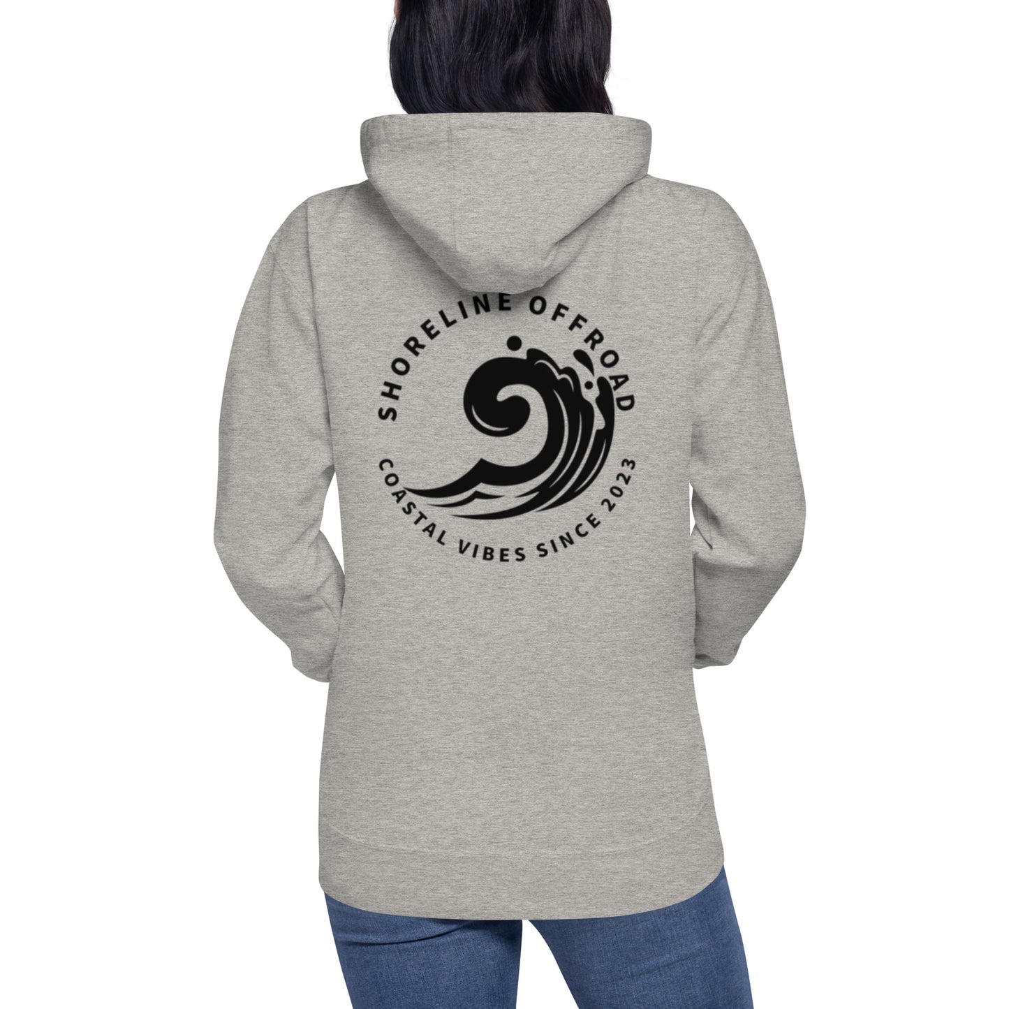 a woman wearing a grey hoodie with a black logo on it