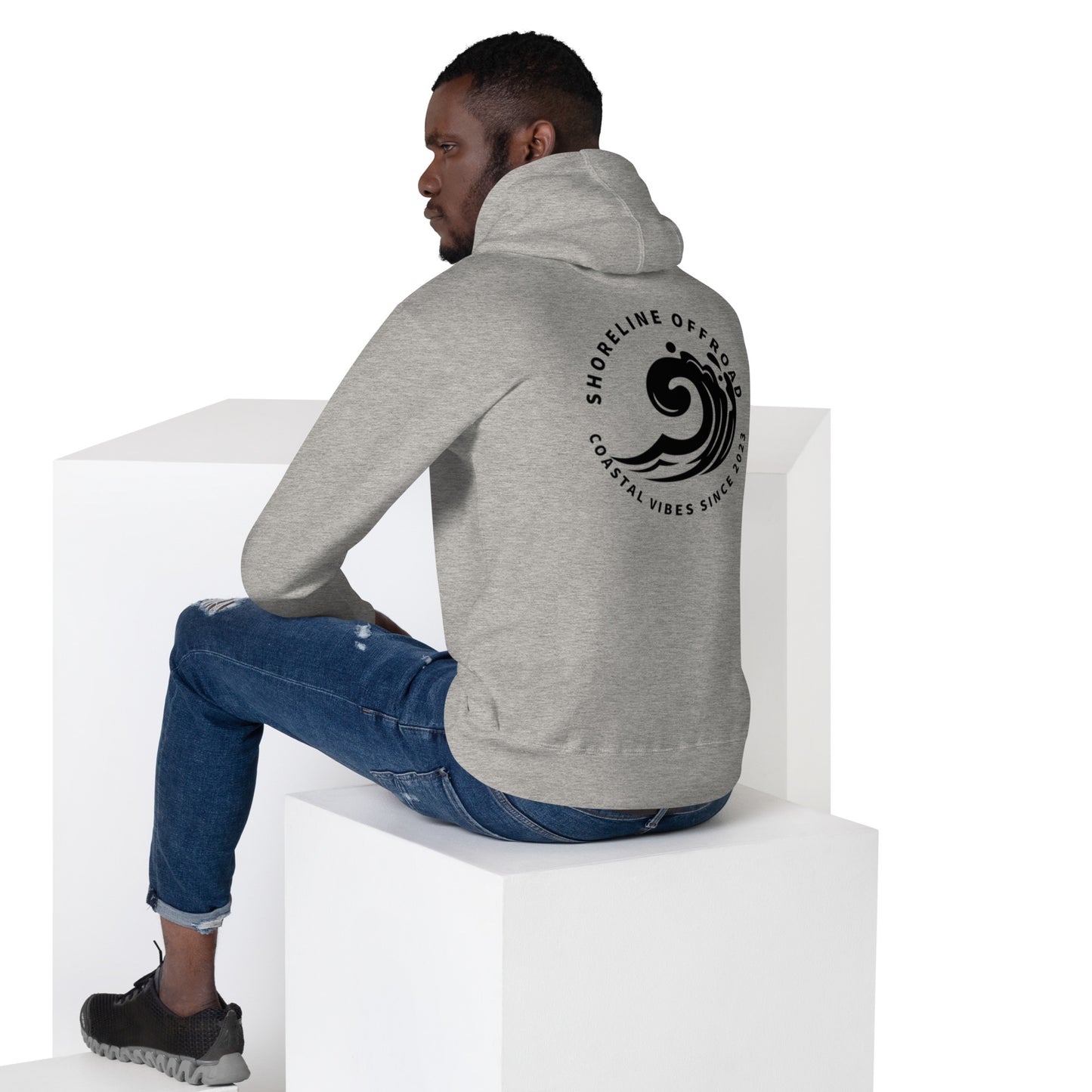 a man sitting on top of a white block