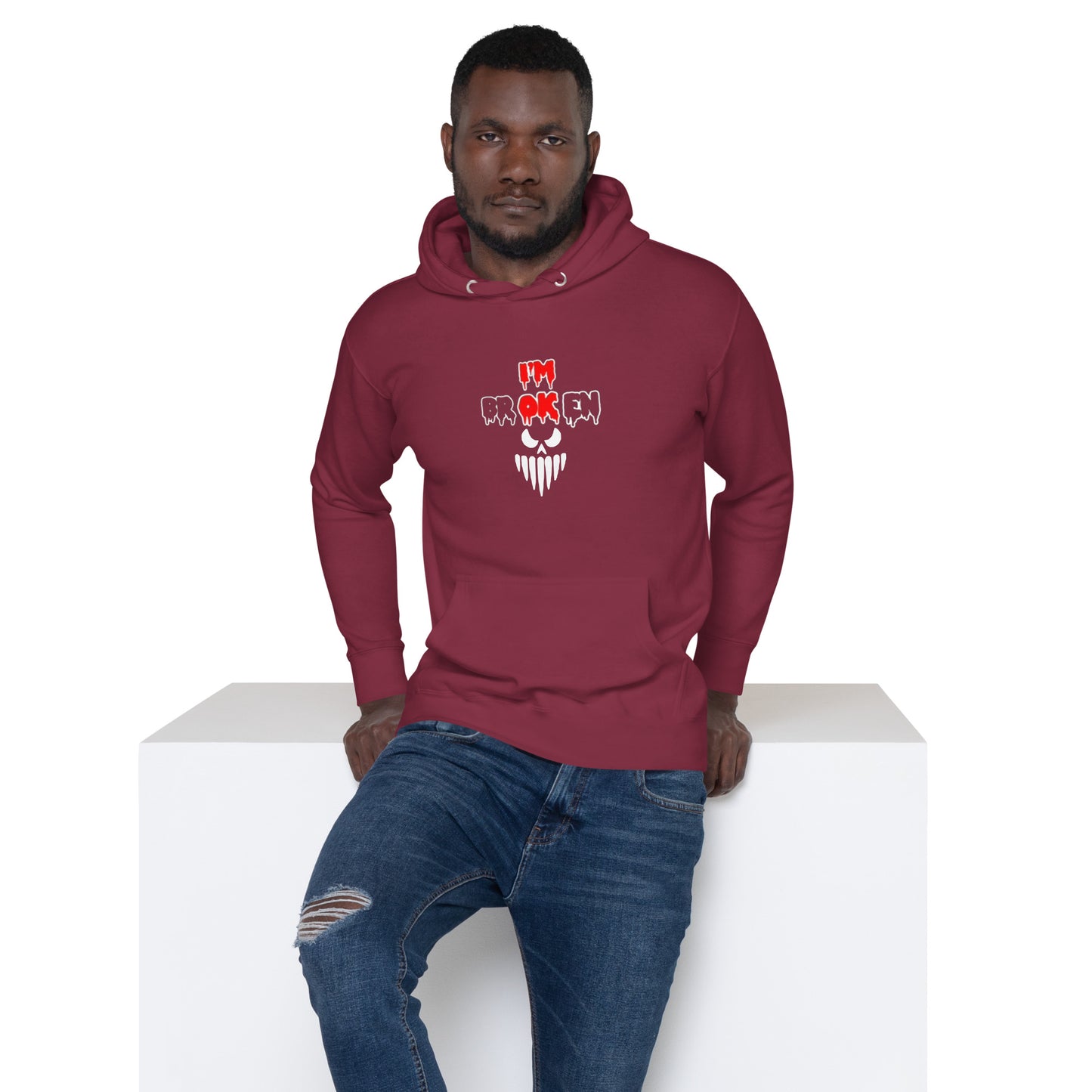 a man wearing a red hoodie with a skull on it
