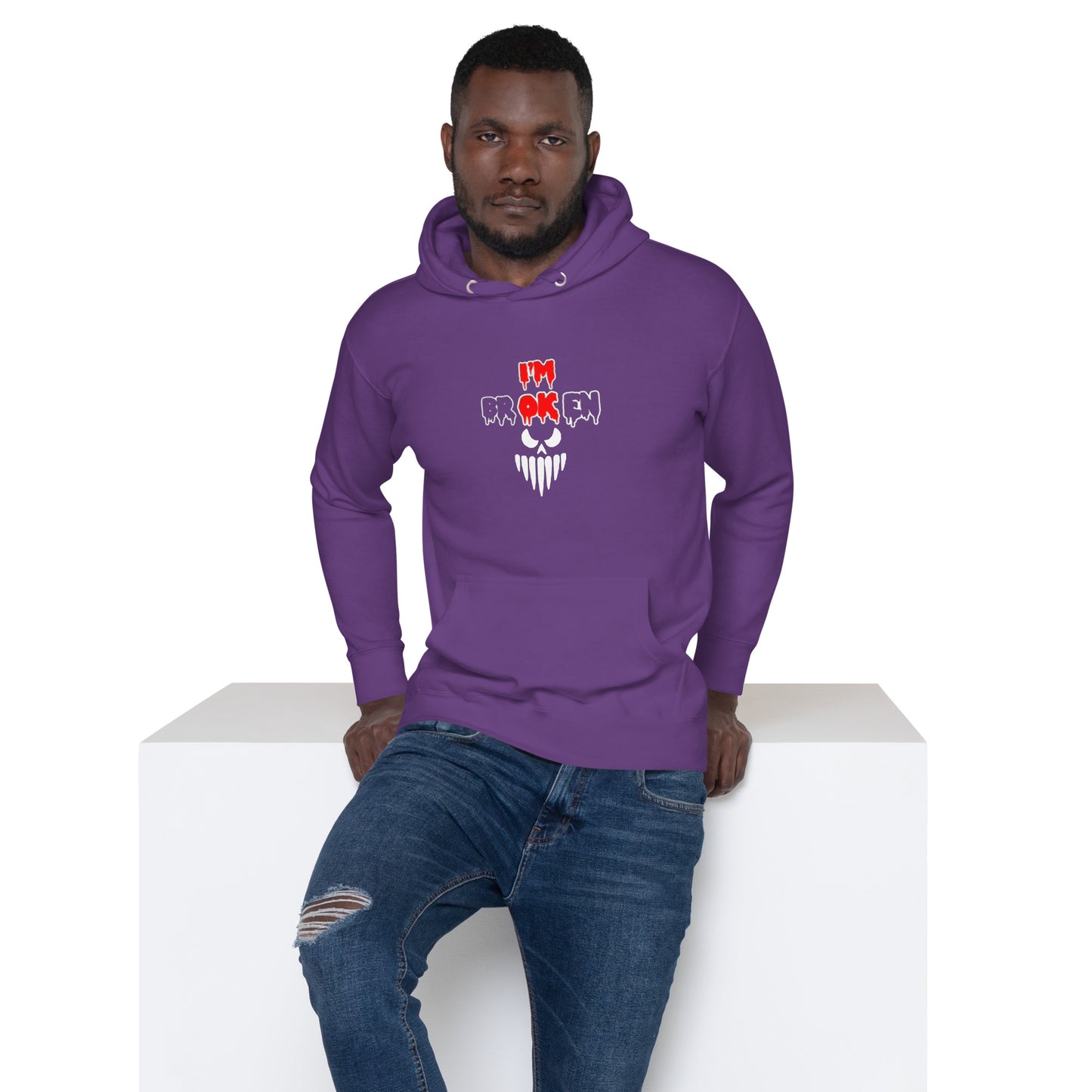 a man wearing a purple hoodie with a skull on it