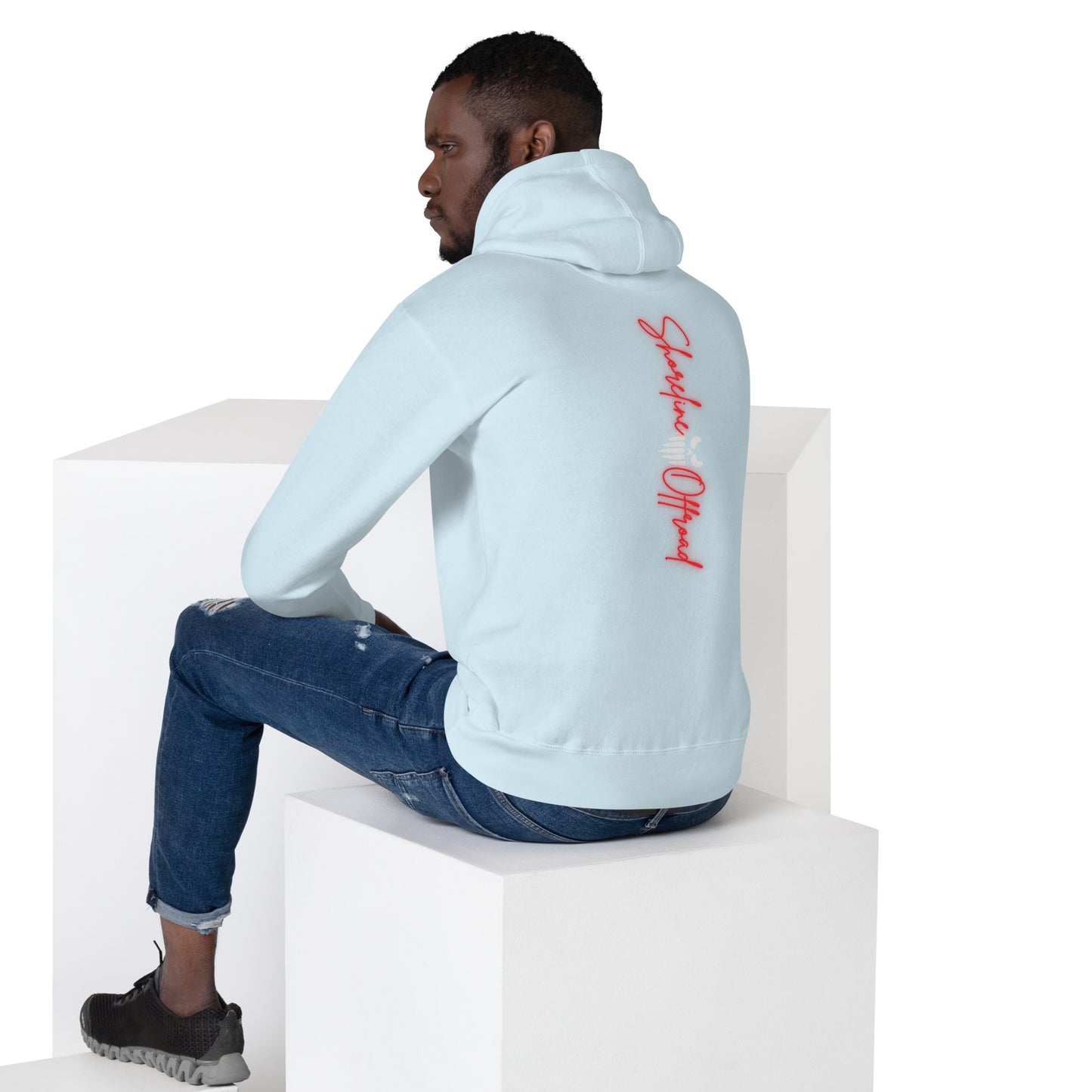 a man sitting on top of a white block