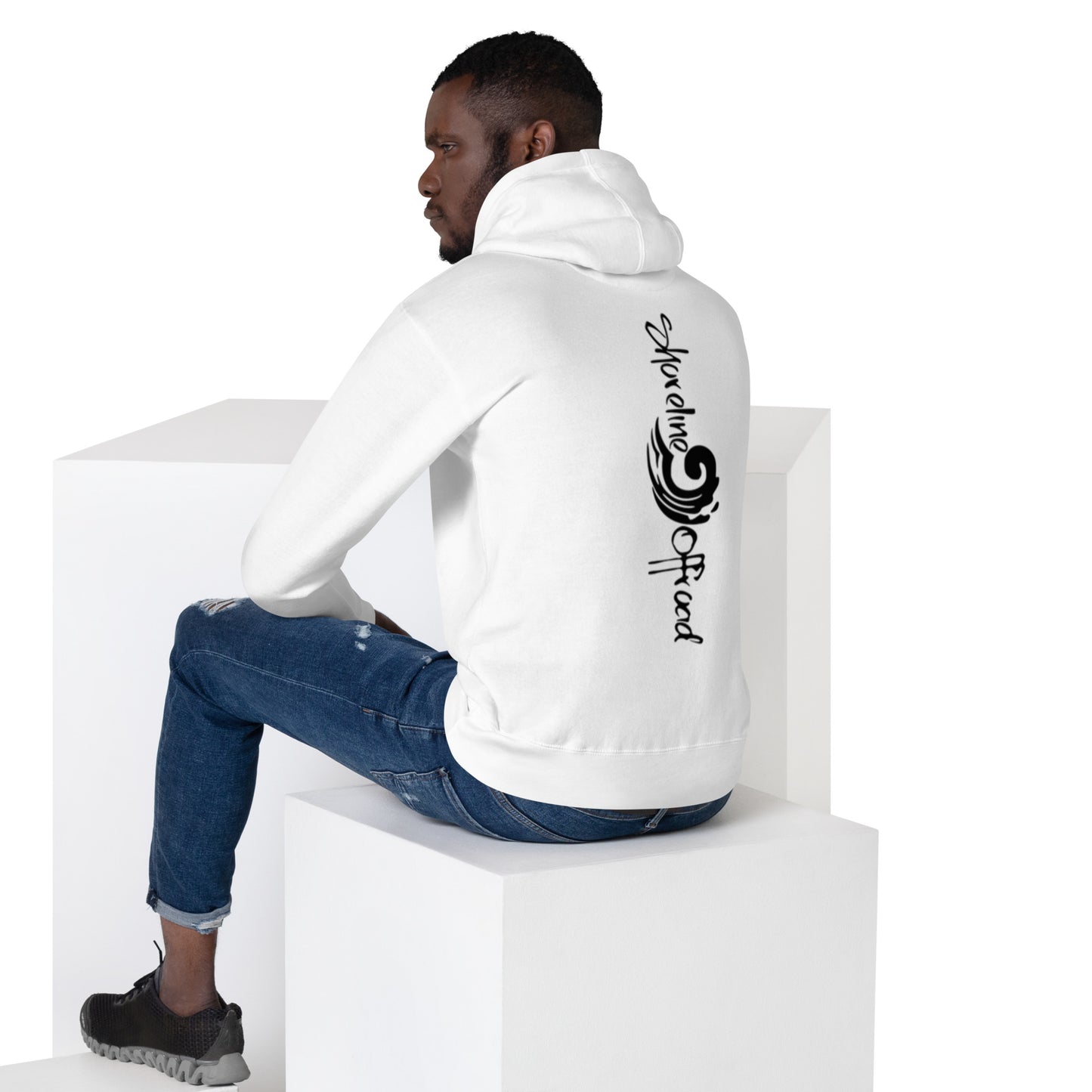 a man sitting on top of a white cube