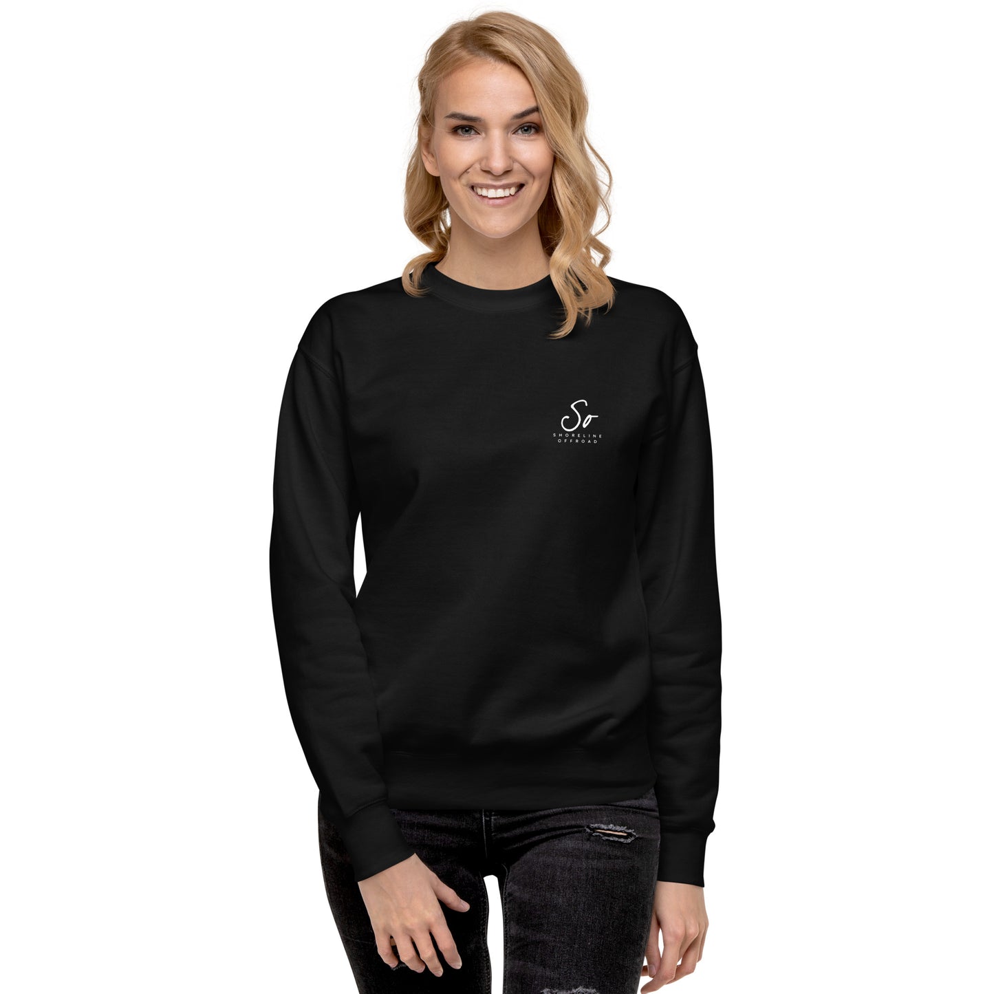 a woman wearing a black sweatshirt with a white logo