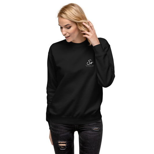 a woman wearing a black sweatshirt and ripped jeans