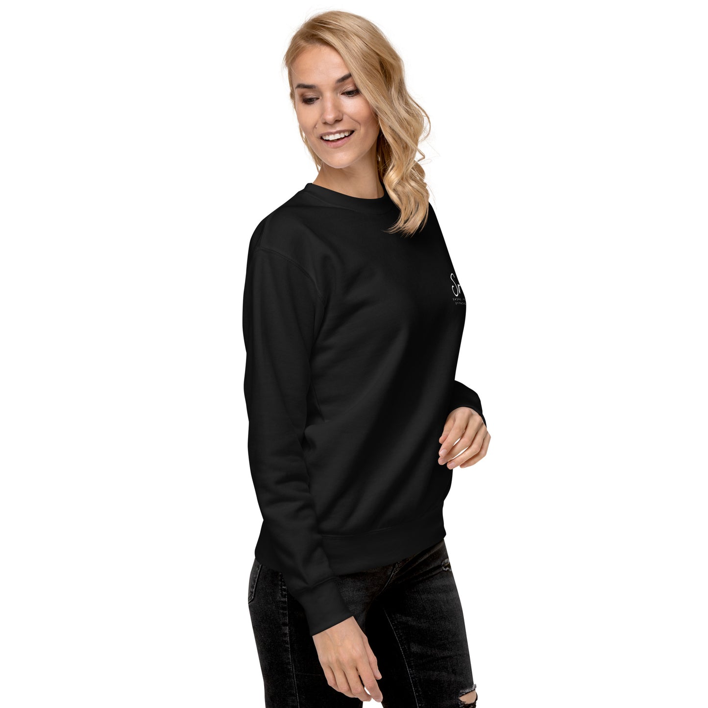 a woman wearing a black sweatshirt and ripped jeans