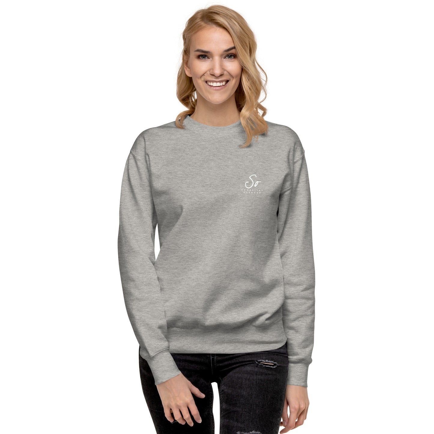 a woman wearing a grey sweatshirt with a white logo