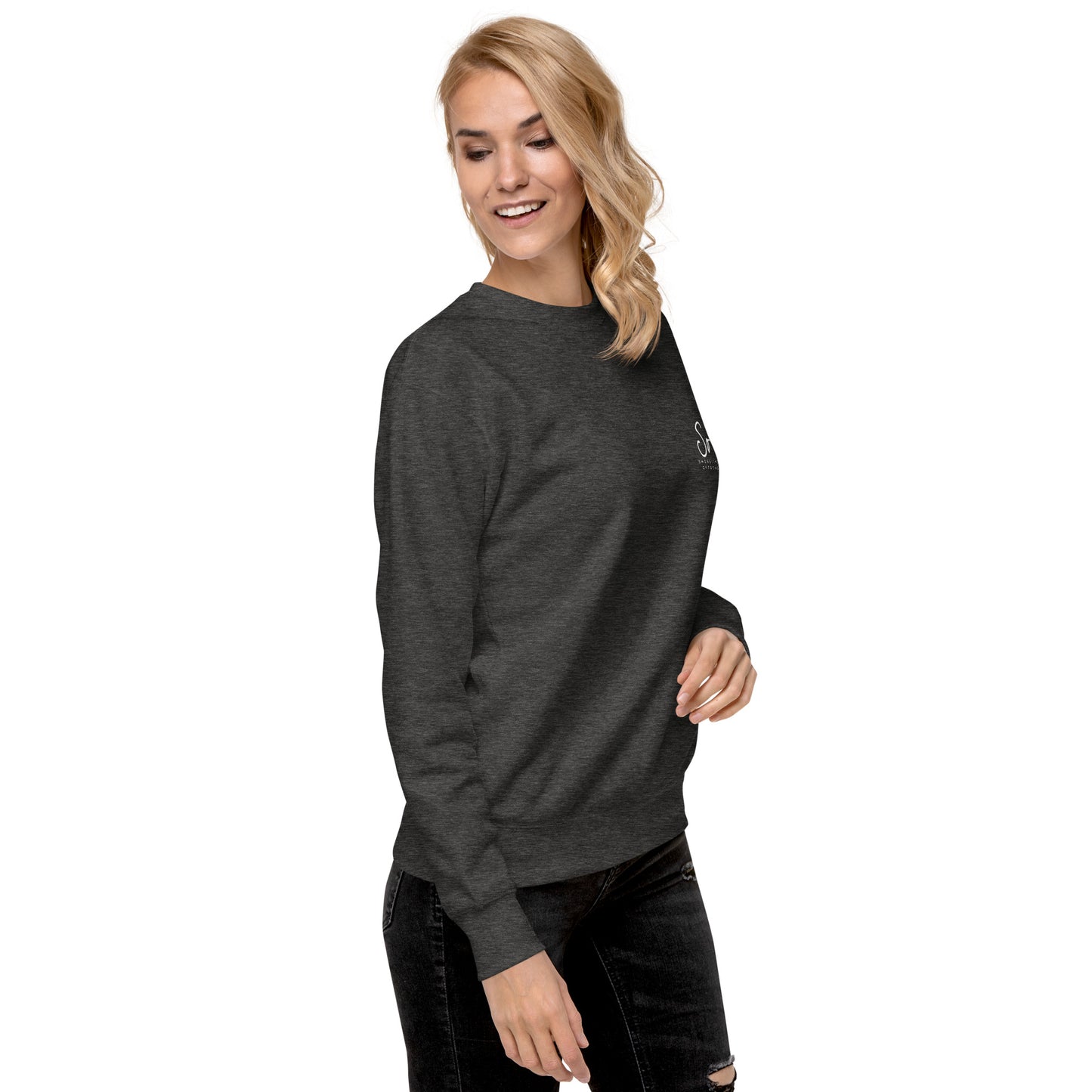 a woman wearing a black sweatshirt and ripped jeans
