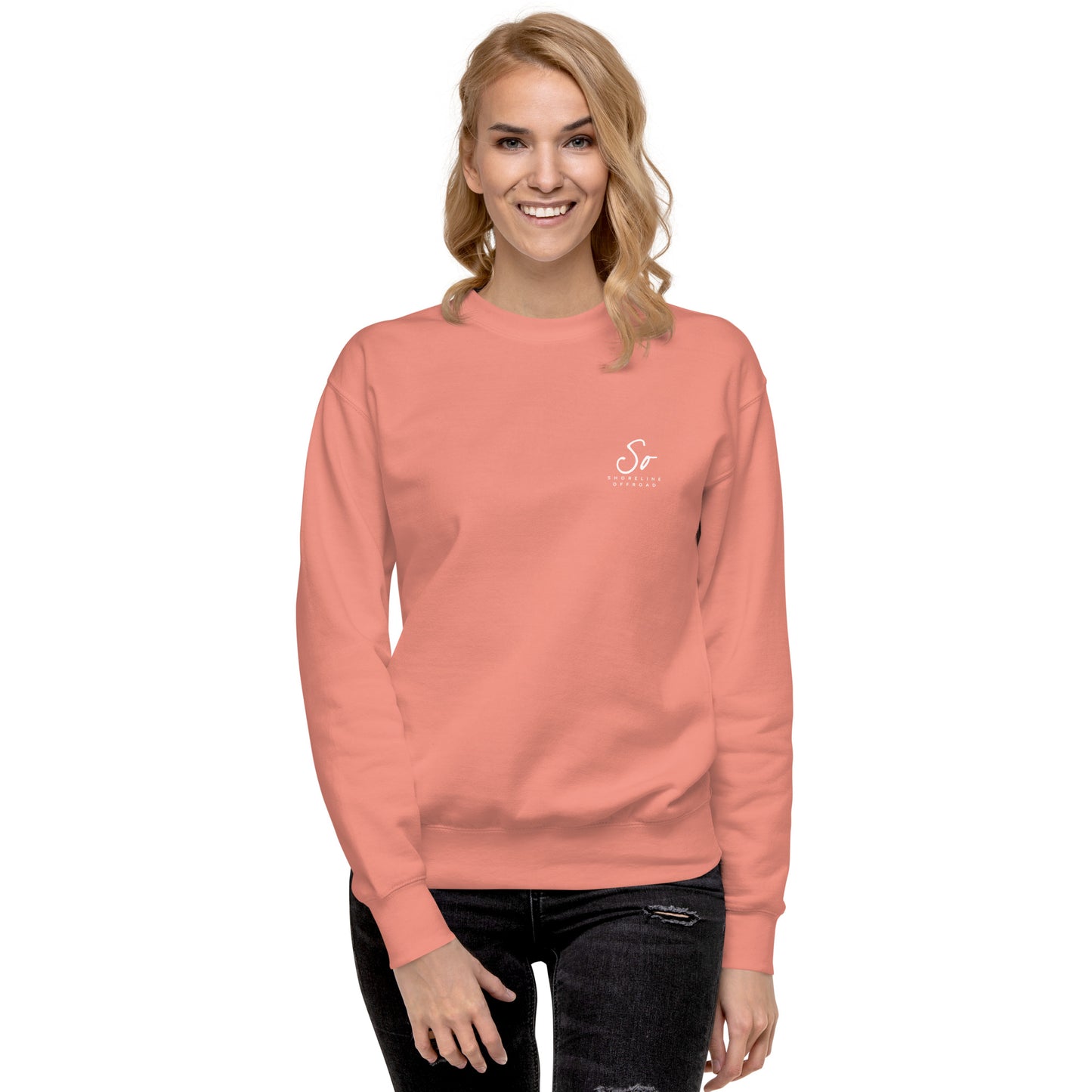 a woman wearing a pink sweatshirt with the letter s on it