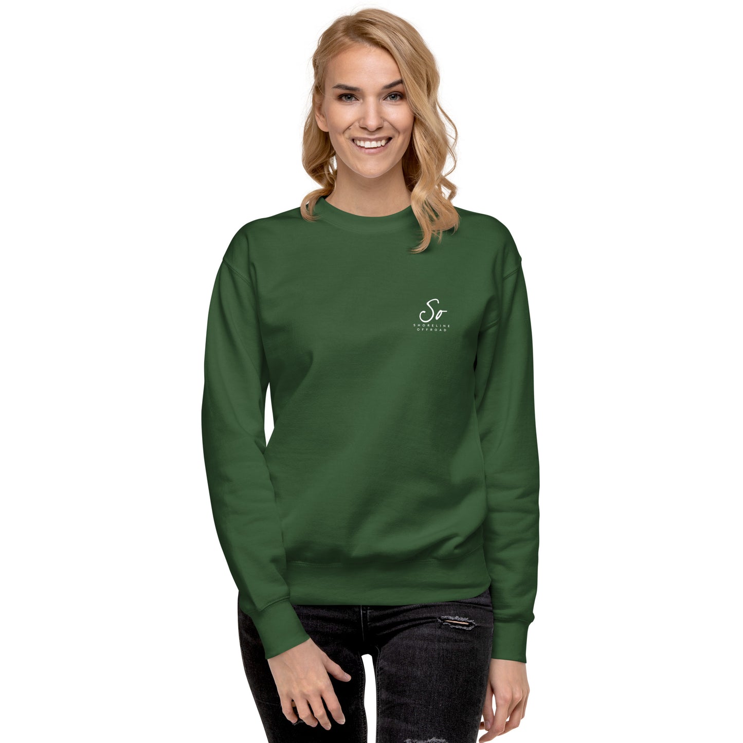 a woman wearing a green sweatshirt with a white logo