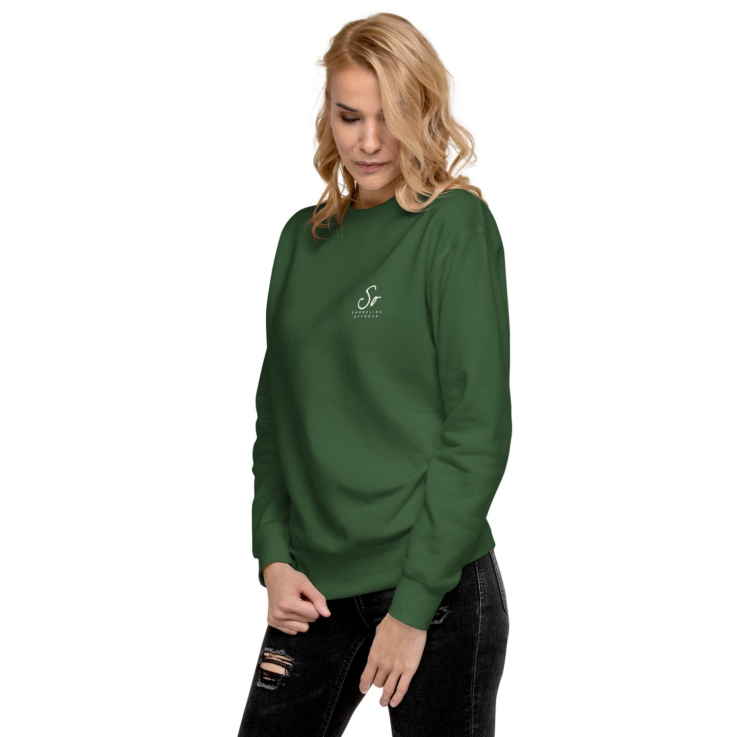 a woman wearing a green sweatshirt with a white logo