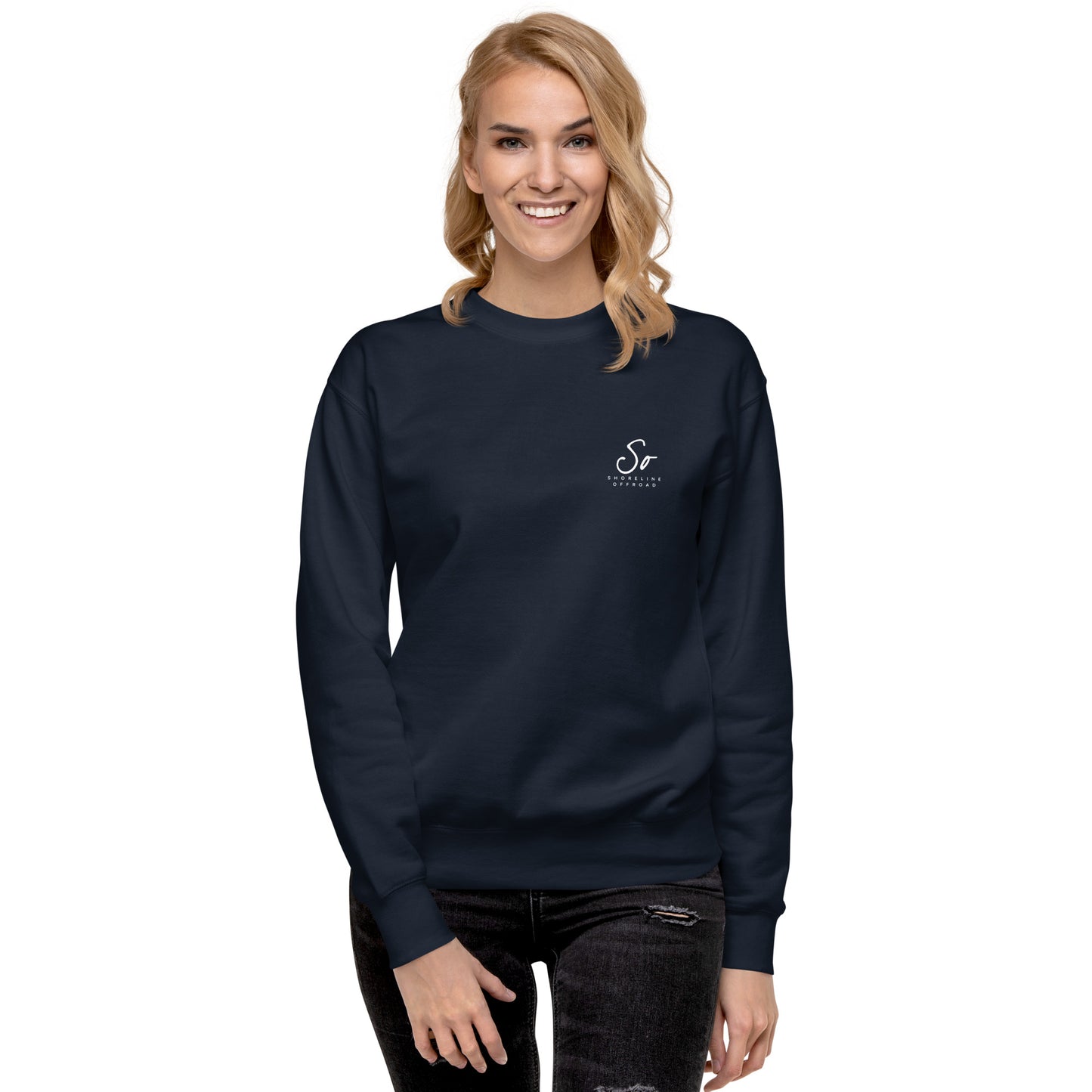a woman wearing a navy sweatshirt with a white logo