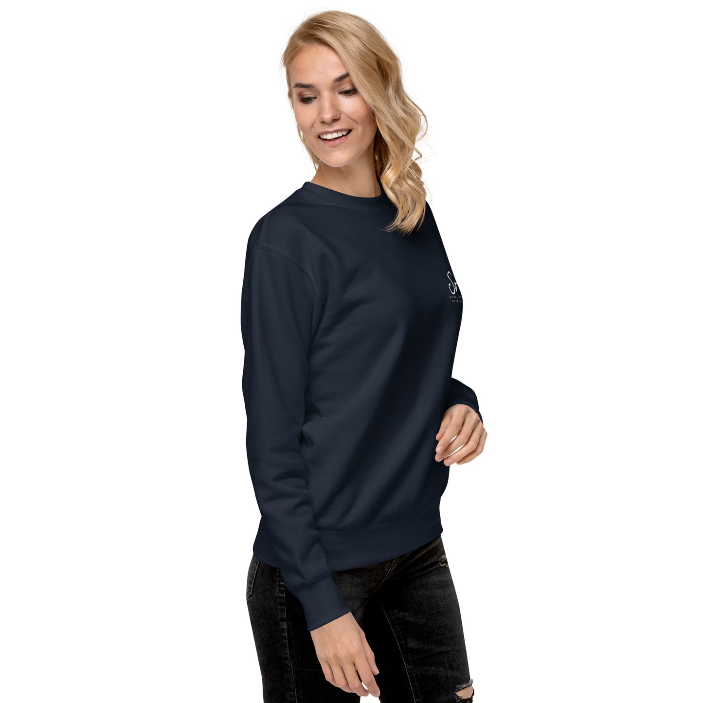 a woman wearing a dark blue sweatshirt and ripped jeans