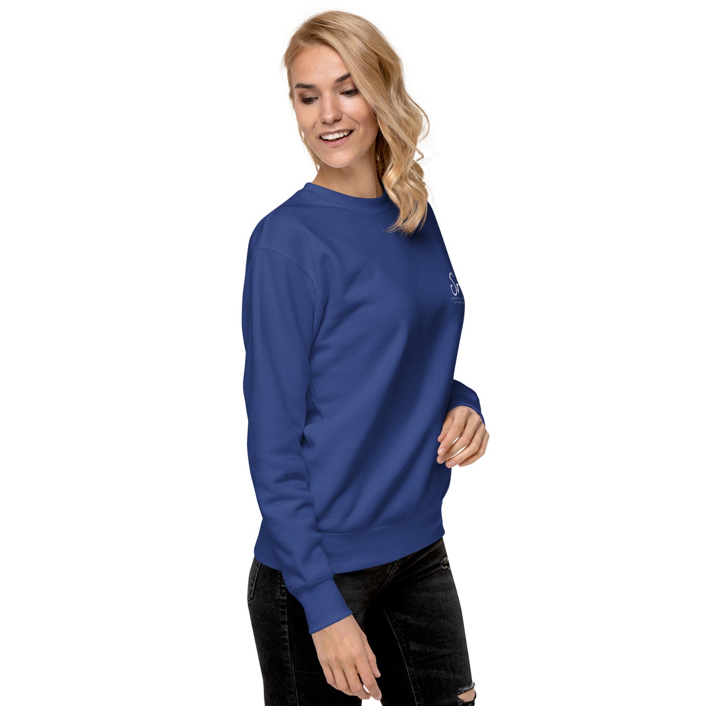 a woman wearing a blue sweatshirt and ripped jeans