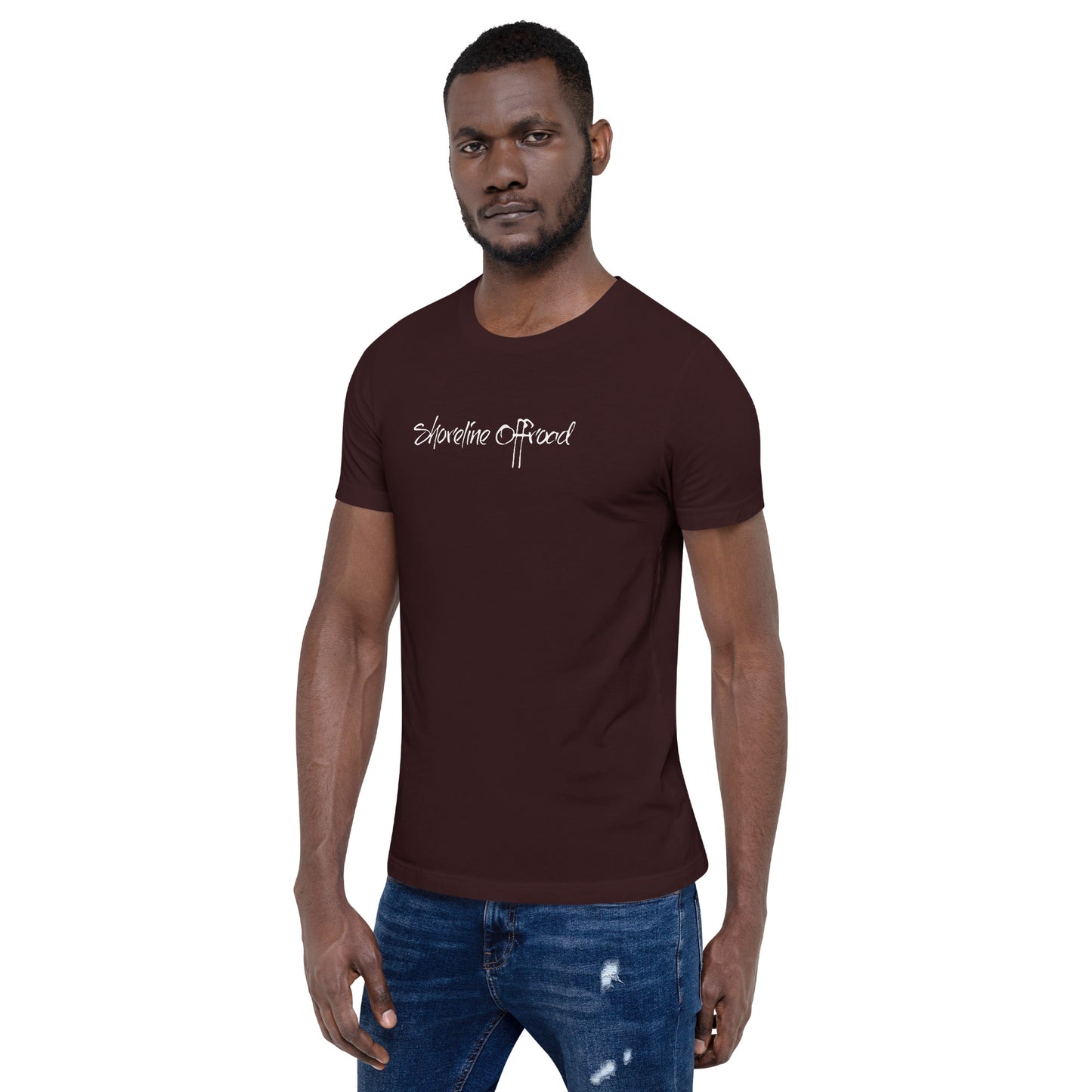 a man wearing a brown shirt and jeans