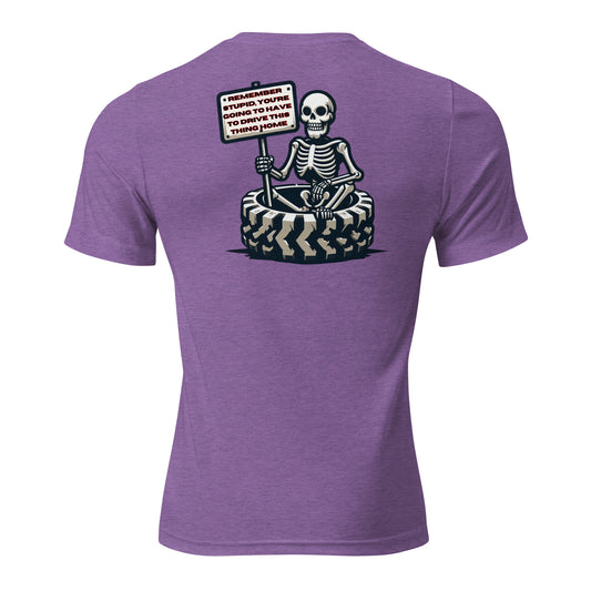 a skeleton sitting on top of a tire holding a sign