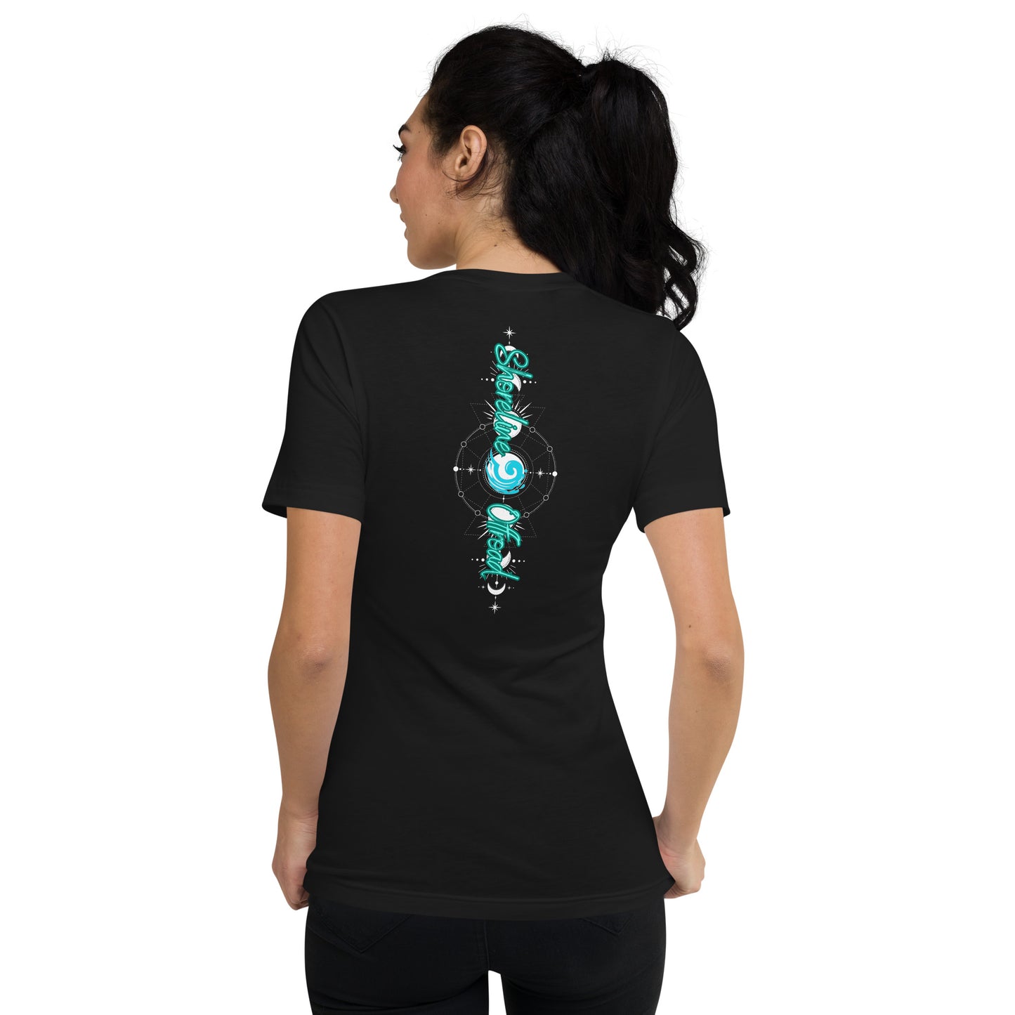 a woman wearing a black t - shirt with green and blue designs on it