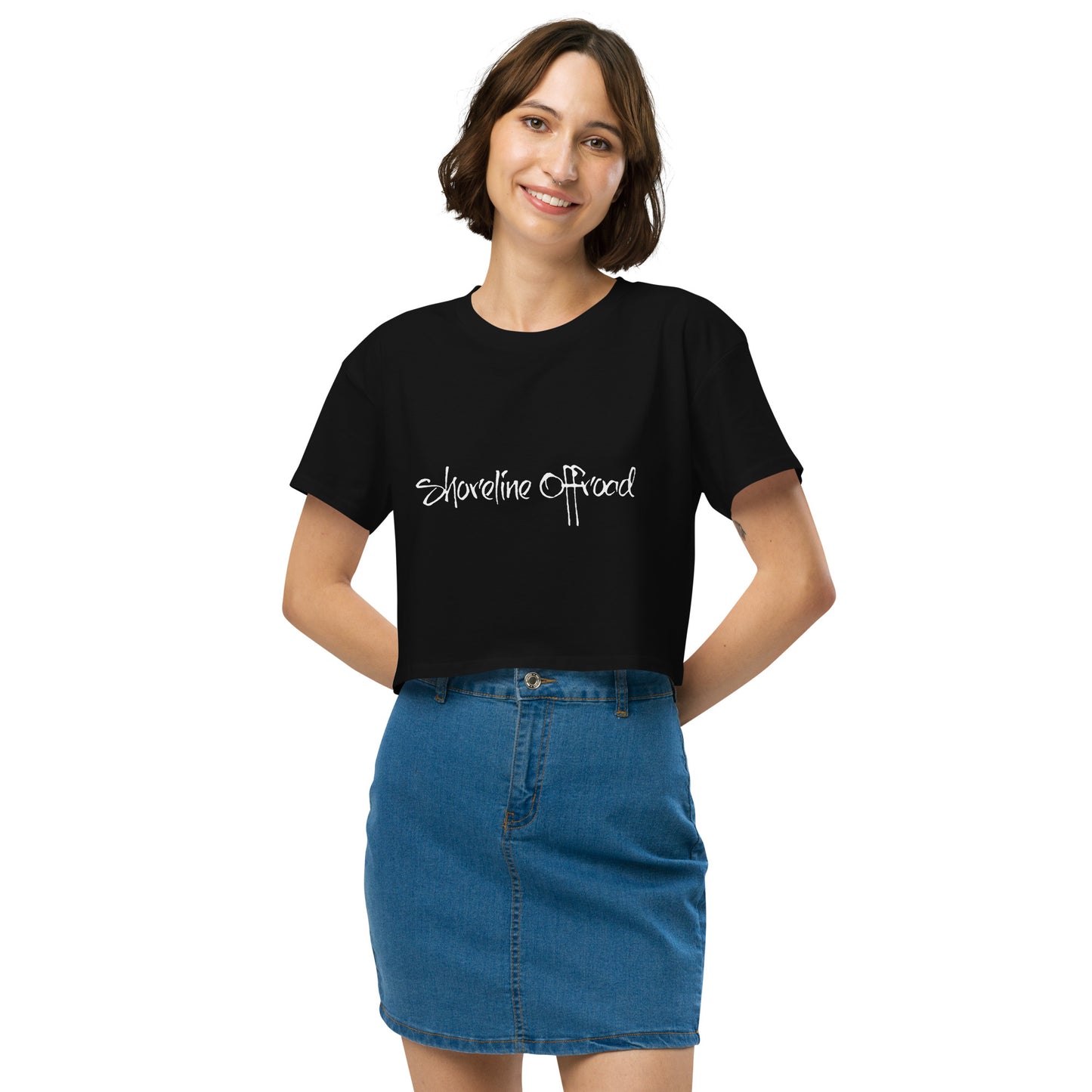 a woman wearing a black shirt and denim skirt