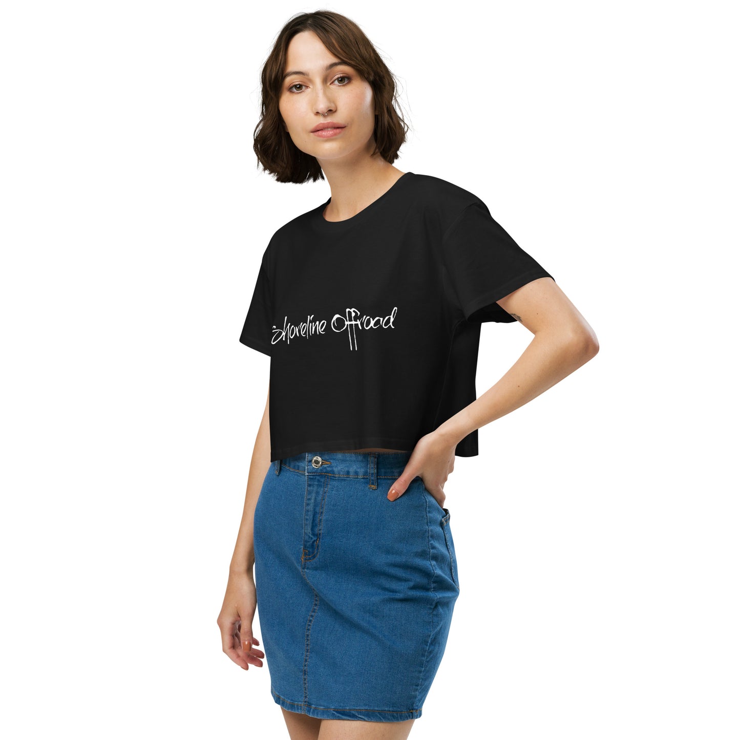 a woman in a black shirt and blue skirt