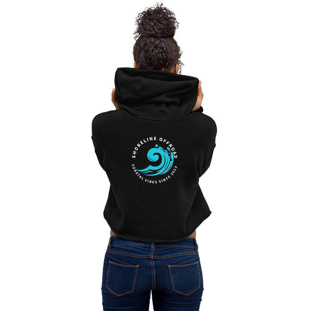 a woman wearing a black hoodie with a blue wave on it