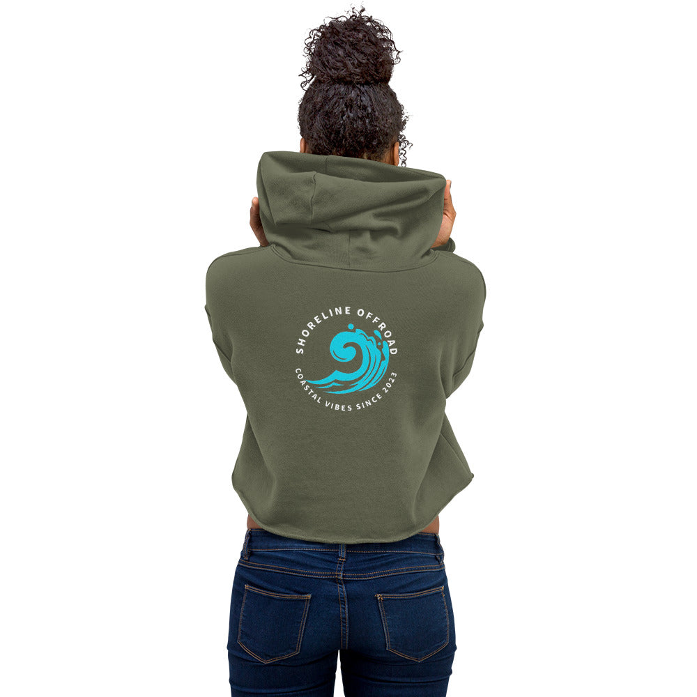 a woman wearing a green hoodie with a blue wave on it