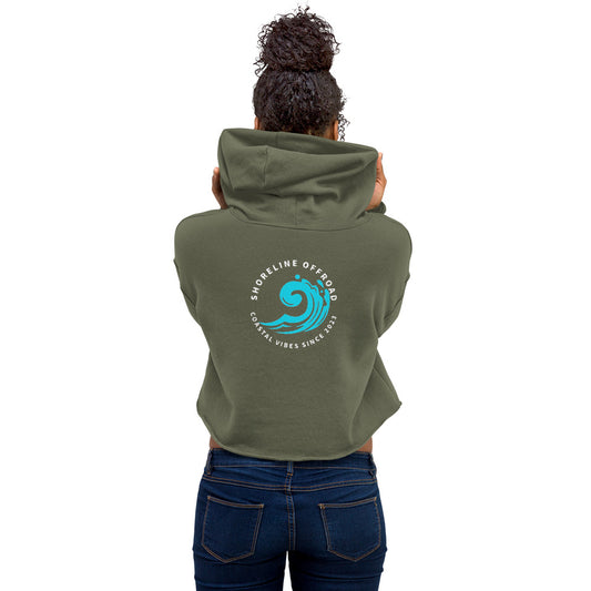 a woman wearing a green hoodie with a blue wave on it