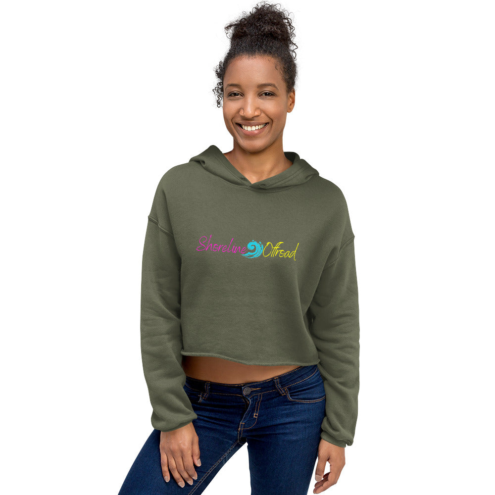 a smiling woman wearing a green hoodie with the words, she's a