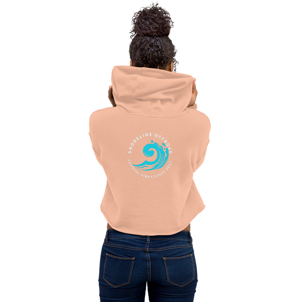 a woman wearing a pink hoodie with a blue wave on it