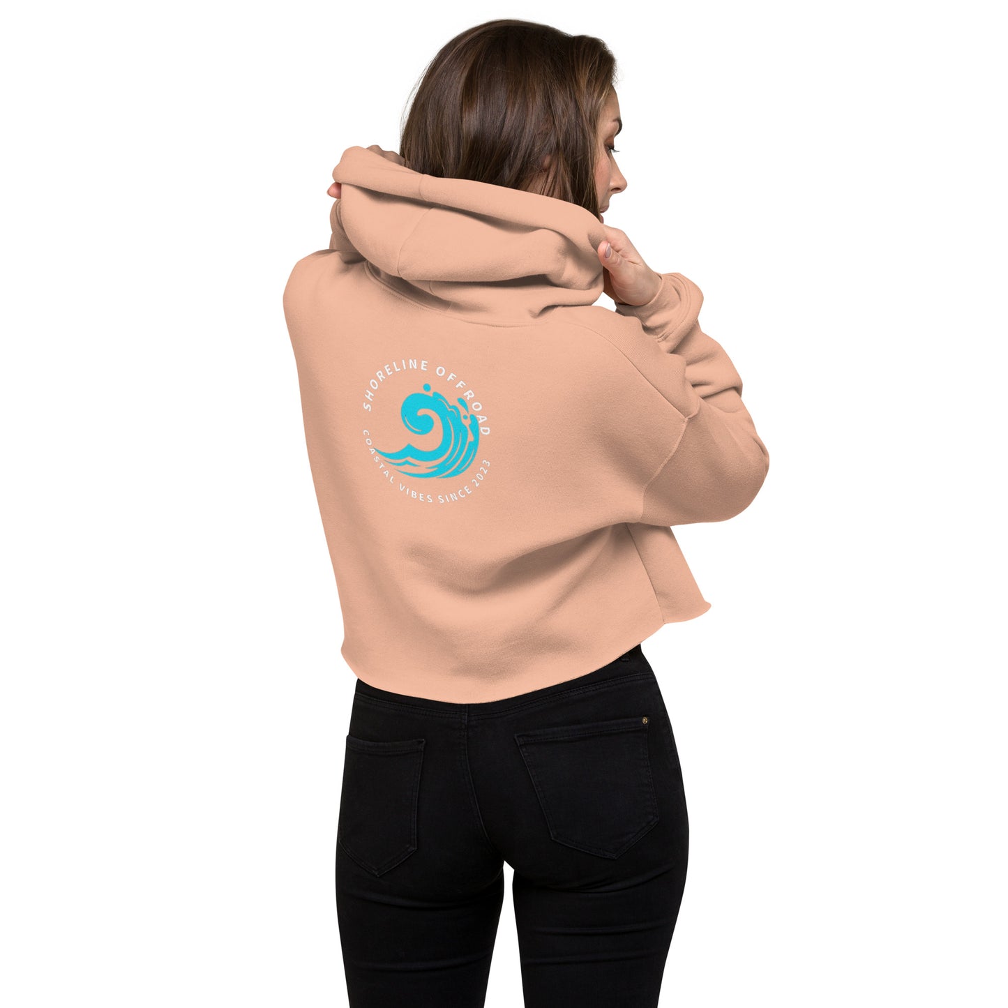a woman wearing a pink hoodie with a blue wave on it