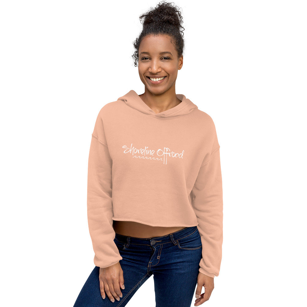a smiling woman wearing a pink crop top