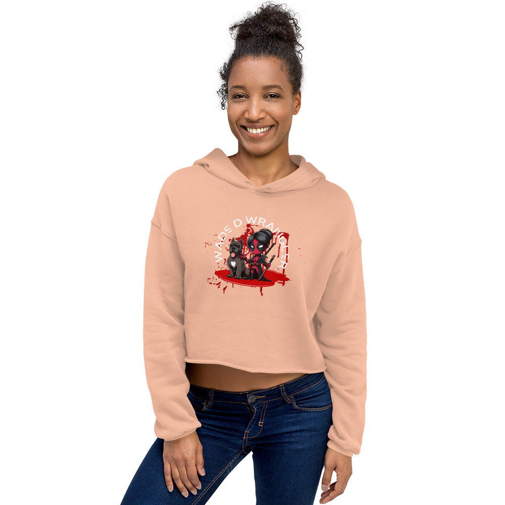 a woman wearing a pink crop top with a black cat on it