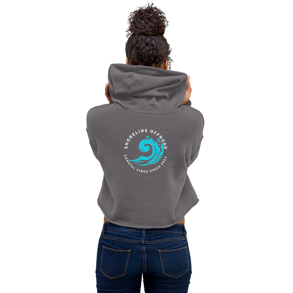 a woman wearing a gray hoodie with a blue wave on it