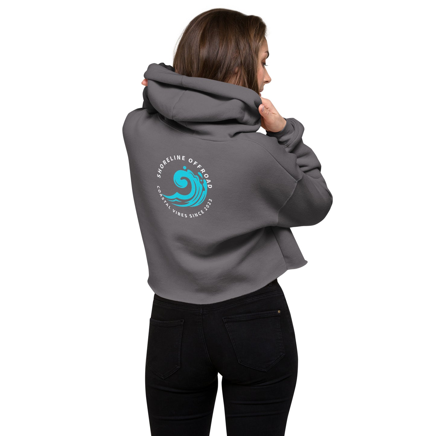a woman wearing a grey hoodie with a blue wave on it