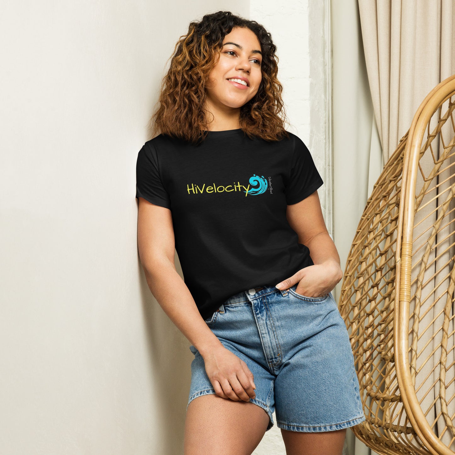 a woman standing next to a wicker chair