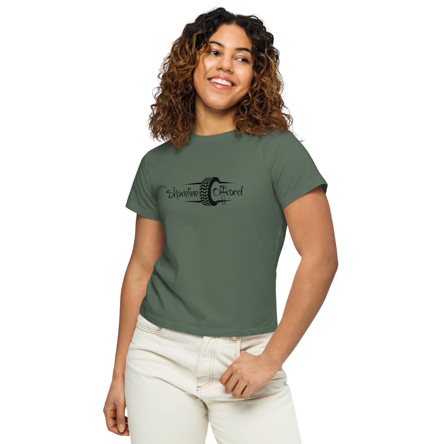 a woman wearing a green shirt and white pants