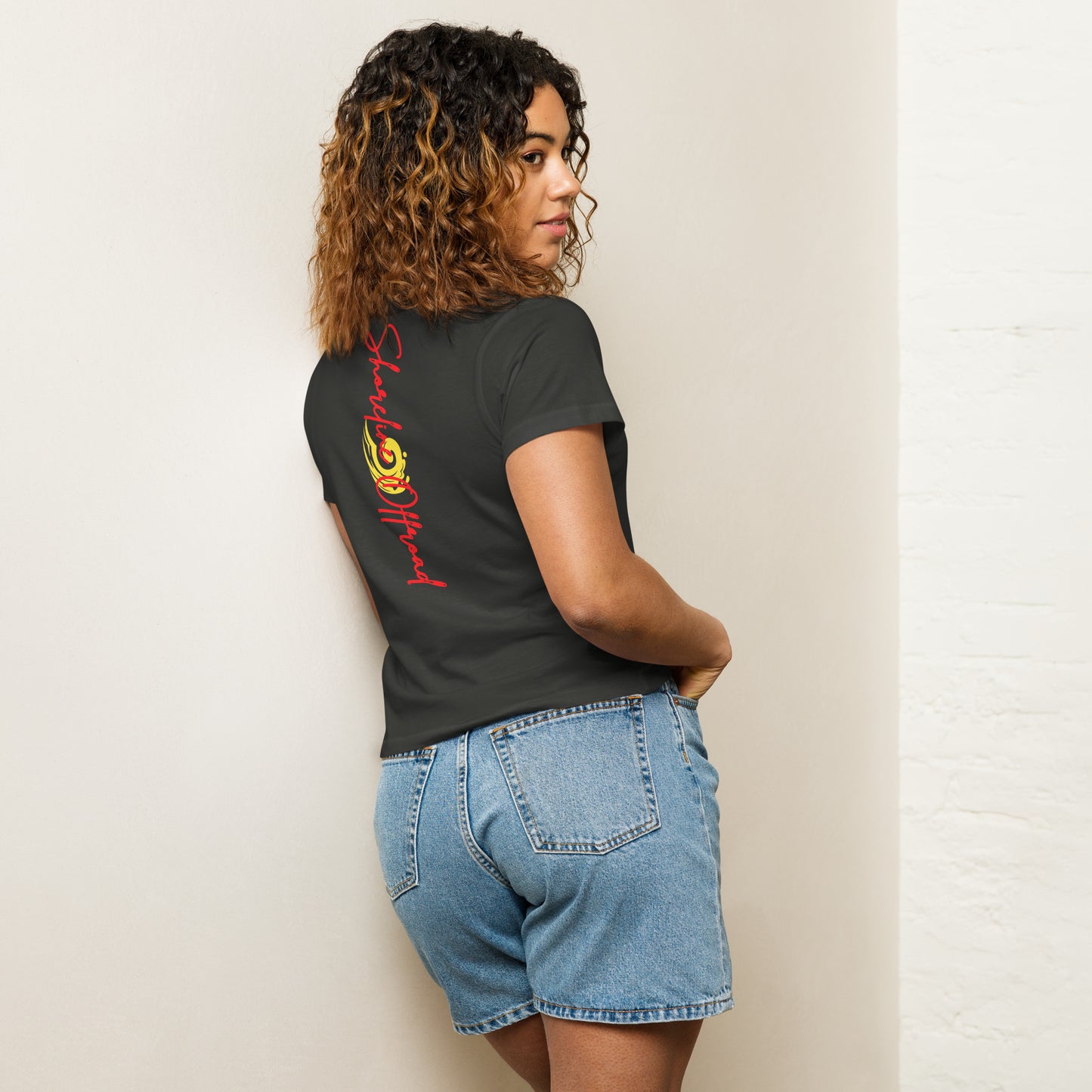 a woman leaning against a wall with her back to the wall