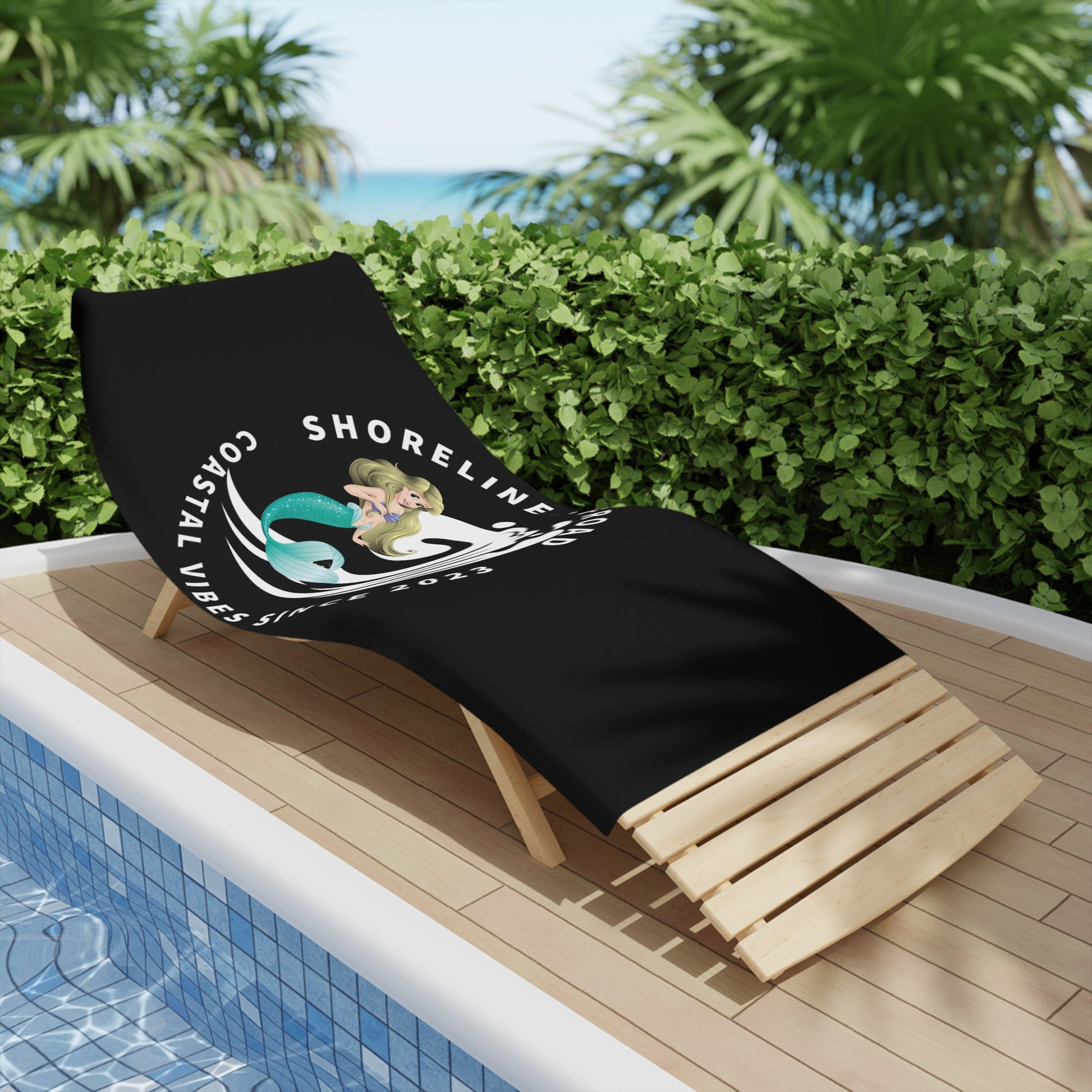 a black beach chair sitting next to a swimming pool