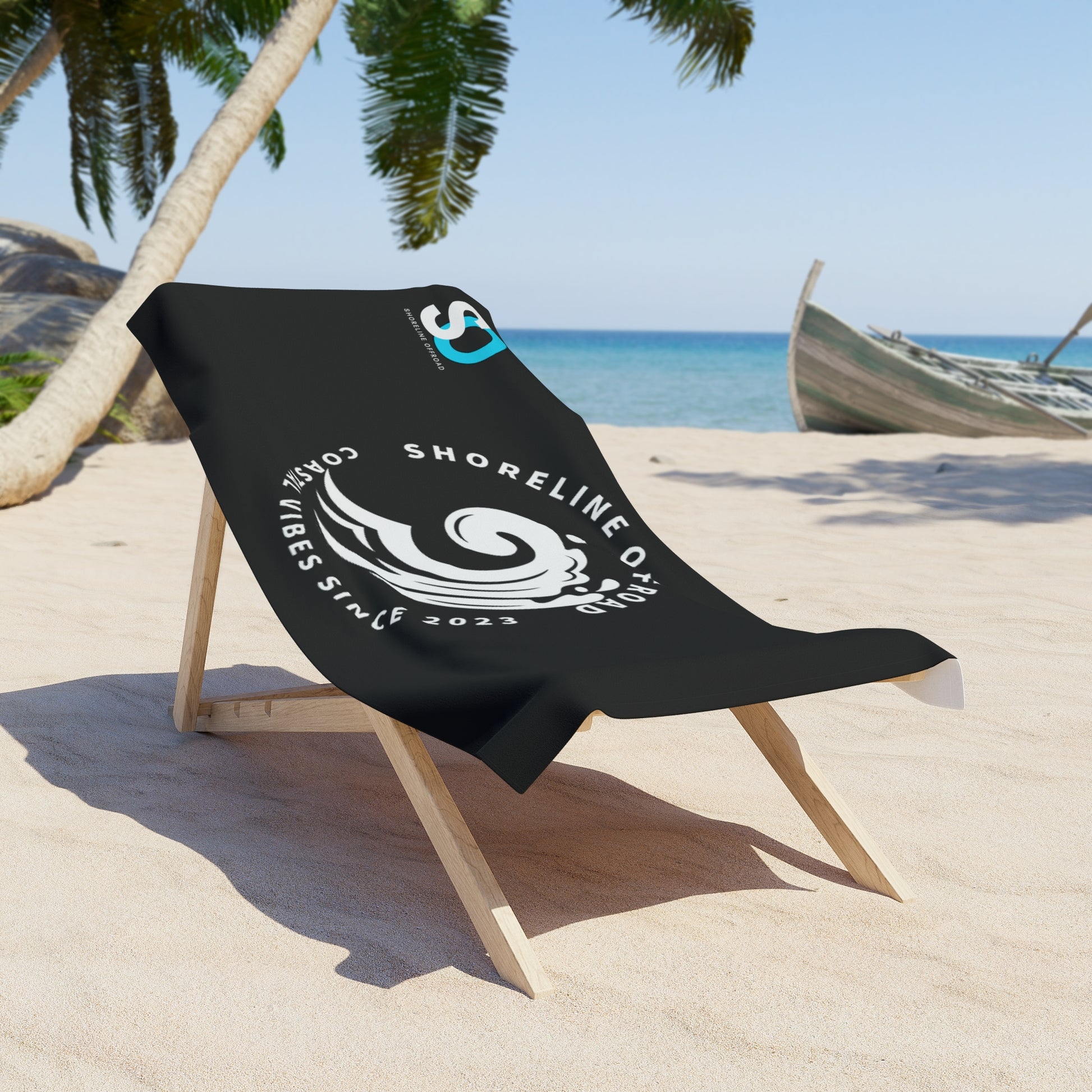 a black beach chair sitting on top of a sandy beach