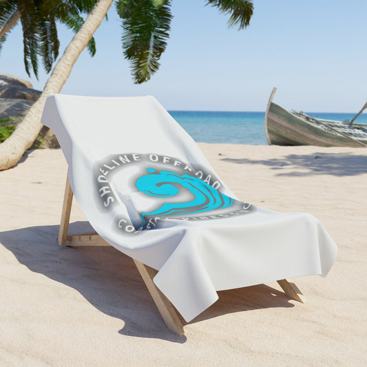 a white beach chair on a sandy beach