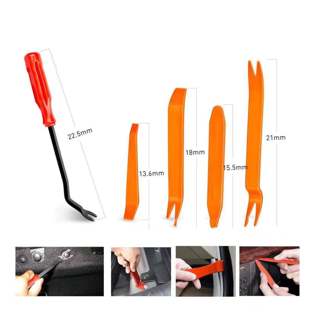 a pair of orange scissors are being used to cut a piece of plastic