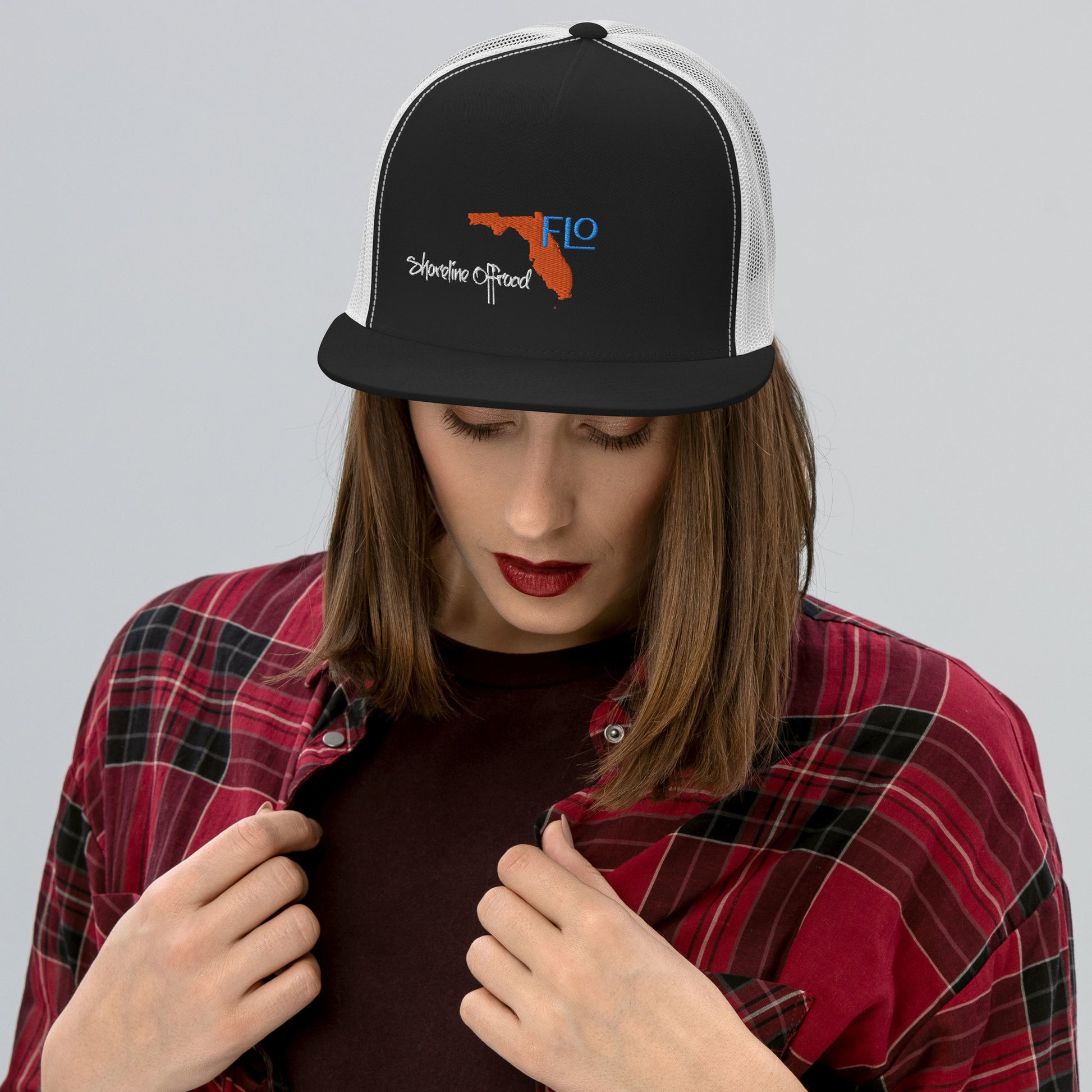 a woman wearing a hat with a logo on it