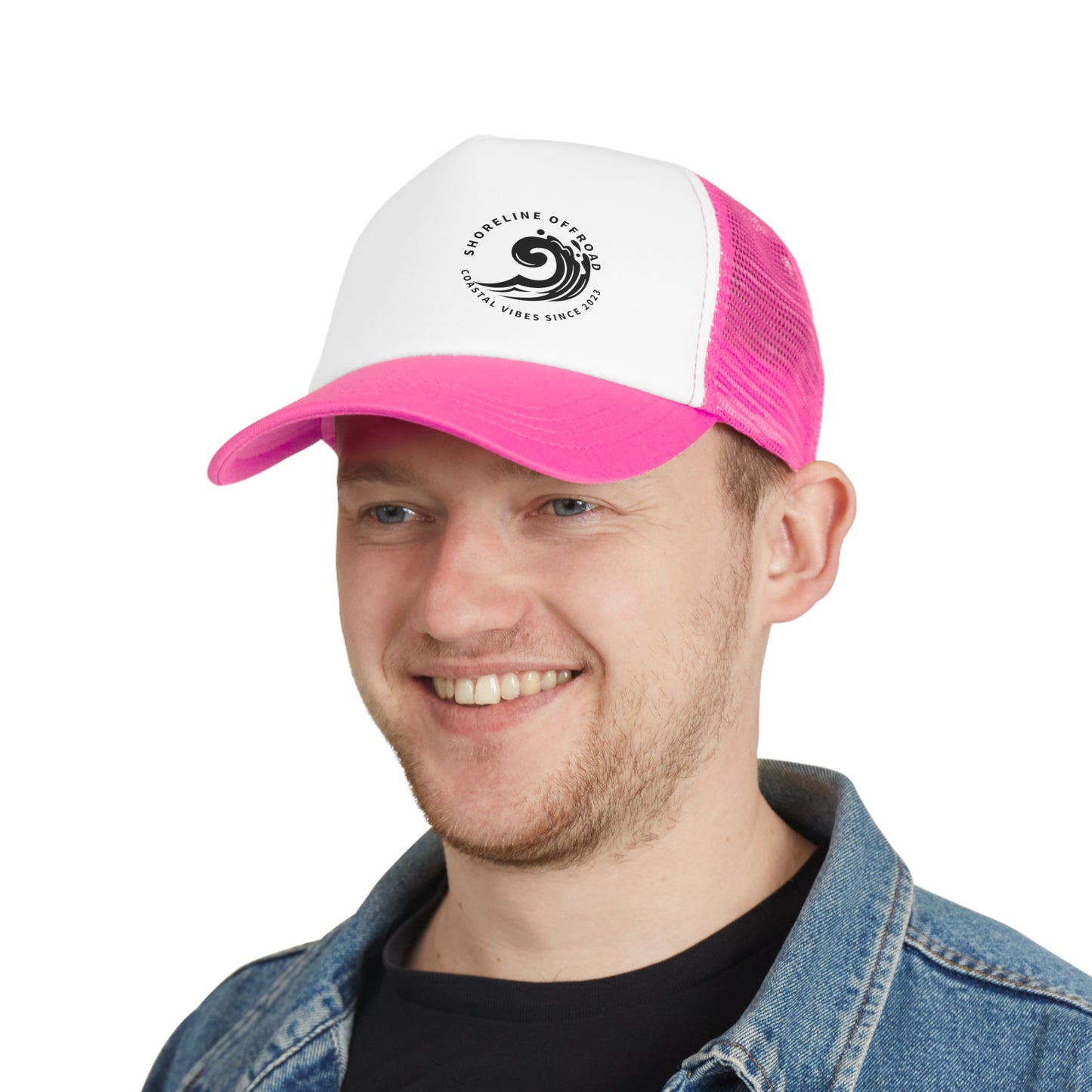 a man wearing a pink and white trucker hat