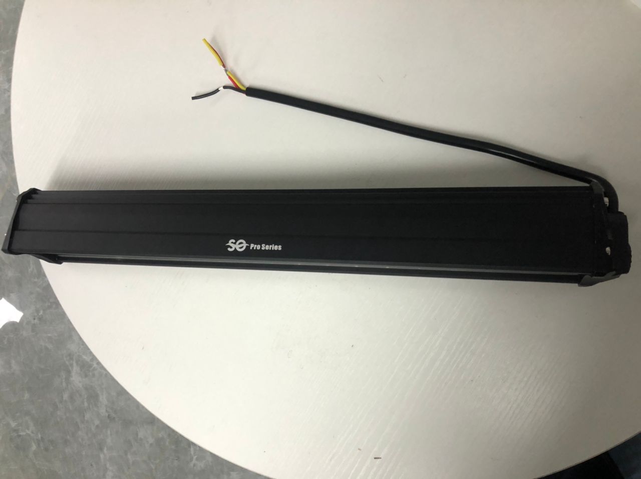 Black LED light bar with wiring on a white background