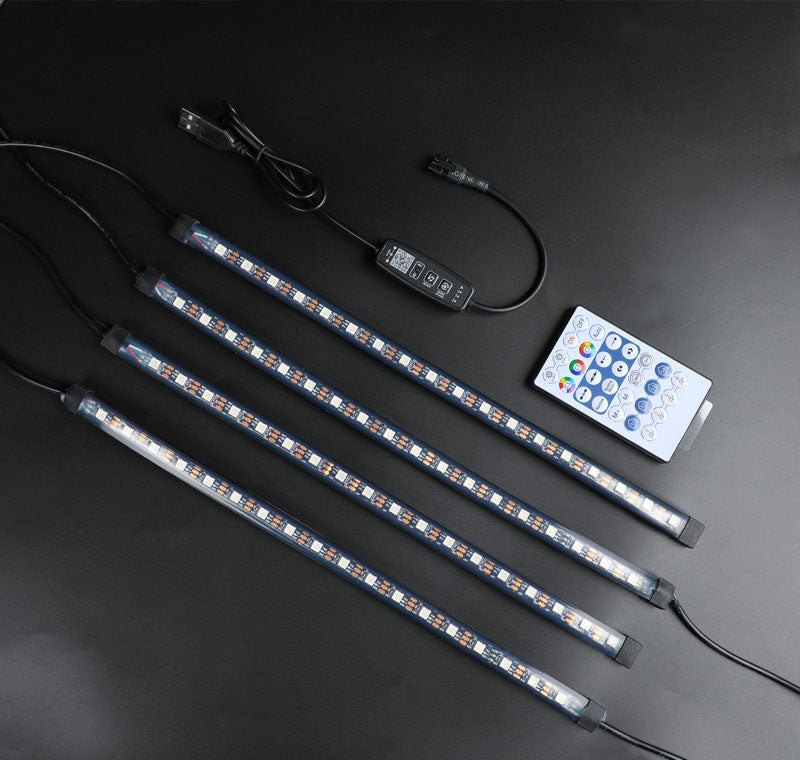 a set of four lights and a remote on a table