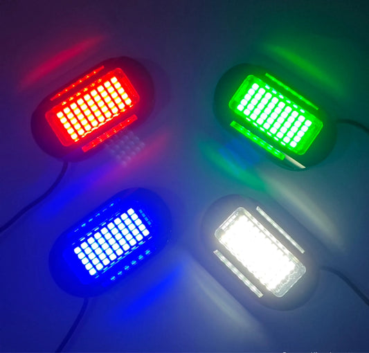 three different colored lights on a white surface